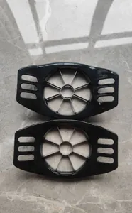 Top view detail of two black manual stainless steel apple slicers and corers on marble floor