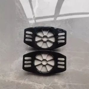 Set of two black stainless steel apple slicers and corers on marble floor surface