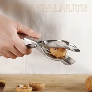Stainless steel nutcracker tool for cracking walnuts and chestnuts on wooden board