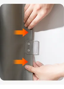 Close-up of a transparent windproof shower curtain clip being applied to fabric.