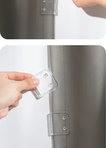 Detail showing the installation of a transparent windproof shower curtain clip on a wall.