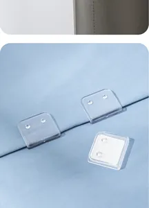 Detailed macro view of transparent adhesive shower curtain clips fixed on light blue fabric