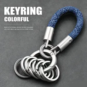 Detail of a blue braided rope keychain with multiple silver rings for car keys.