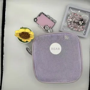 Minimalist lavender square mesh makeup bag with zip closure and bear logo patch