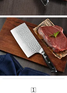 Hammered kitchen cleaver detail, sharp stainless steel blade with ergonomic wooden handle.