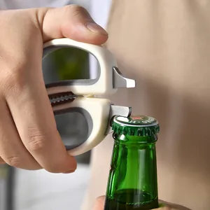 Multi-functional stainless steel kitchen scissors opening a green beer bottle cap
