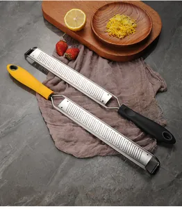 Macro view of handheld stainless steel cheese grater and lemon zester for kitchen