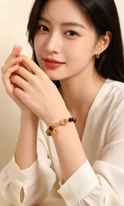 Close-up of a natural yellow tiger eye bracelet with a gold heart charm on a model's wrist