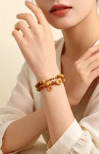Detail view of natural yellow tiger eye double-layer bracelet on woman's wrist