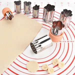 Complete 8-piece stainless steel vegetable and cookie cutter set with orange hand guards