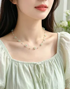 Close-up of green crystal flower bead necklace worn by a female model in forest style.