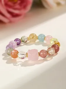 Macro view of multi-color Super Seven crystal bracelet featuring a pink sugar cube bead