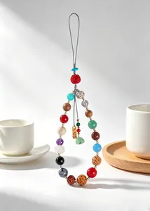 Close-up of traditional 18-seed multi-gemstone phone charm with lucky wealth charm