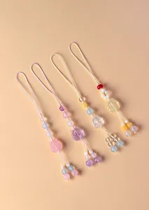 Detailed view of four colorful nine-tailed fox natural crystal beaded phone straps charms