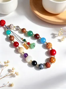 Detailed close-up of colorful eighteen-seed Bodhi bead phone strap with golden peace tag