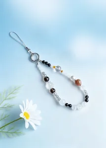 Detailed macro view of a stylish white phantom quartz nine-tailed fox beaded phone strap