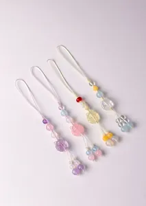 Detail of four cute nine-tailed fox natural crystal beaded phone charms in various colors