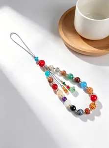Detailed view of handcrafted 18-bead phone charm with diverse gemstone textures
