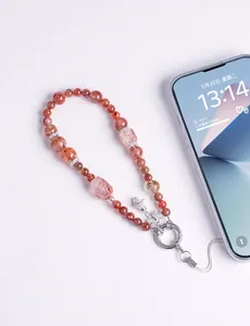 High-quality natural strawberry crystal beaded phone strap with sparkling bow charm detail