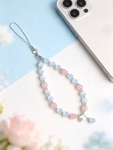 Detail view of a pink and blue cat eye stone beaded phone strap with a star charm.