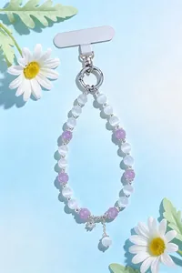 Detail view of purple and white cat's eye beaded phone strap with floral accents