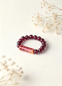 Detailed view of natural garnet beaded ring with a textured agate cylindrical bead.