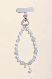 Close-up detail of natural cat's eye beaded phone lanyard with silver star pendant