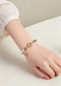 Close-up of freshwater pearl and Hetian jade beaded bracelet with Ping An Kou charm