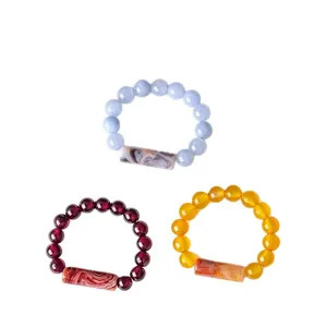 Set of natural garnet and agate beaded elastic rings with marbled tube bead details.