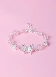 Close-up of pink crystal beaded bracelet with intricate silver butterfly and flower charms.