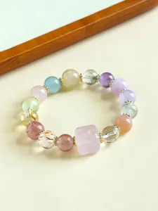 Close-up of a colorful natural stone bracelet featuring rose quartz and amethyst beads.