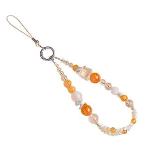 Natural crystal beaded phone strap charm with jade and shell on white background