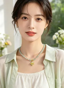 Detailed shot of an Asian model wearing the green aventurine and pearl necklace.