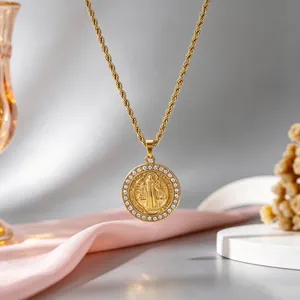 Close-up of vintage gold stainless steel religious pendant necklace with crystal halo.