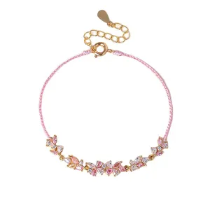 Elegant pink cord bracelet featuring sparkling crystal butterfly floral charms for women.