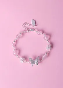 Elegant close-up of a lavender amethyst beaded bracelet featuring a silver butterfly charm.