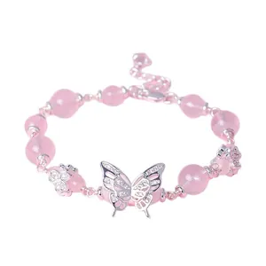 Elegant pink beaded bracelet with silver butterfly and flower charms for women.