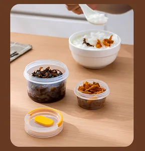 Transparent airtight plastic food storage containers for pickles in a breakfast scene.