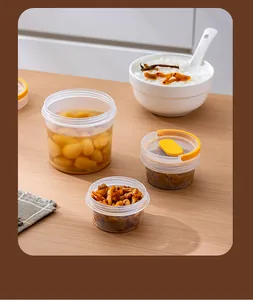 Transparent airtight pickle storage containers with yellow lids on a wooden table