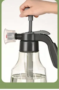 Detailed view of a manual pressure spray bottle pump mechanism being operated by hand