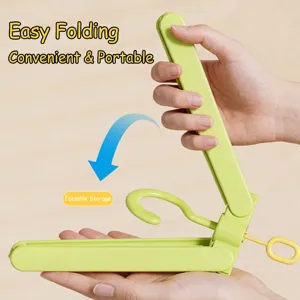 Portable lime green folding clothes hanger designed for travel laundry and compact storage