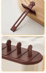 Detail view of brown silicone popsicle mold with cute paw-shaped sticks for DIY ice cream