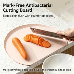 Modern pink TPU antibacterial cutting board on a white marble kitchen counter with carrot slices