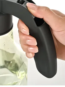 Close-up of ergonomic black handle on versatile spray bottle held by hand for cleaning