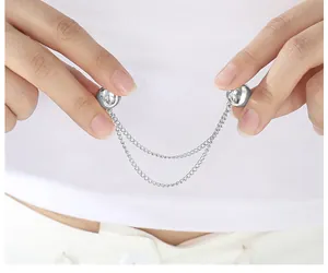 Macro detail of silver magnetic buckle with double chains for shortening T-shirt hems