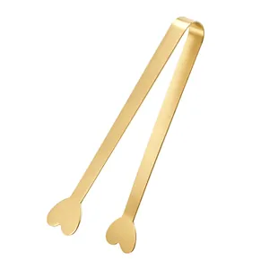 Elegant gold stainless steel heart-shaped sugar tongs for ice cubes and lemon slices.