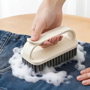 Ergonomic multi-functional laundry brush with soft bristles for cleaning clothes.