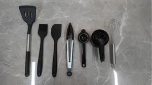 Comprehensive 7-piece kitchen utensil set with spatula, whisk, and measuring cups.
