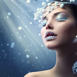 Macro detail of sparkling face gem stickers and pearls for bridal or stage costume makeup
