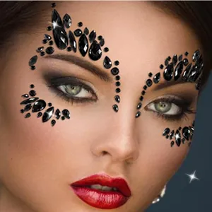 Close-up detail of black teardrop and round face jewels for dramatic dark eye makeup look